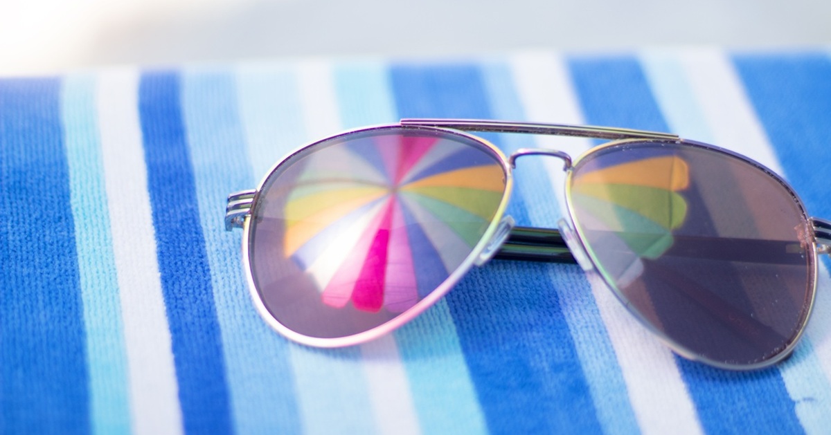 Pair of sunglasses on a stripped towel