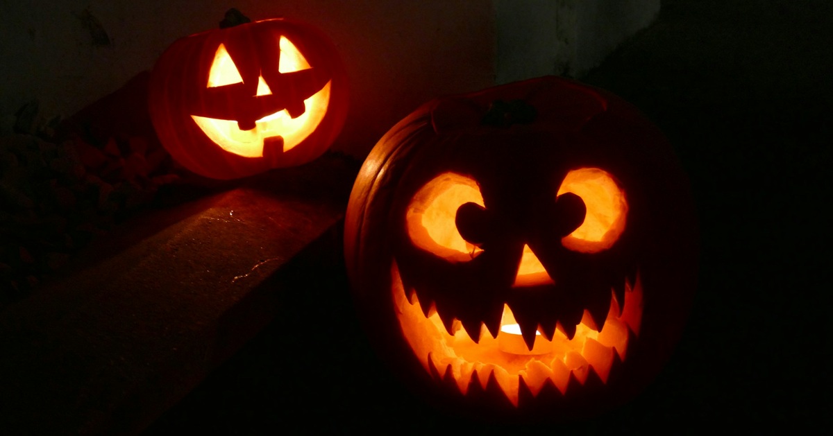 A pair of carved glowing pumpkins