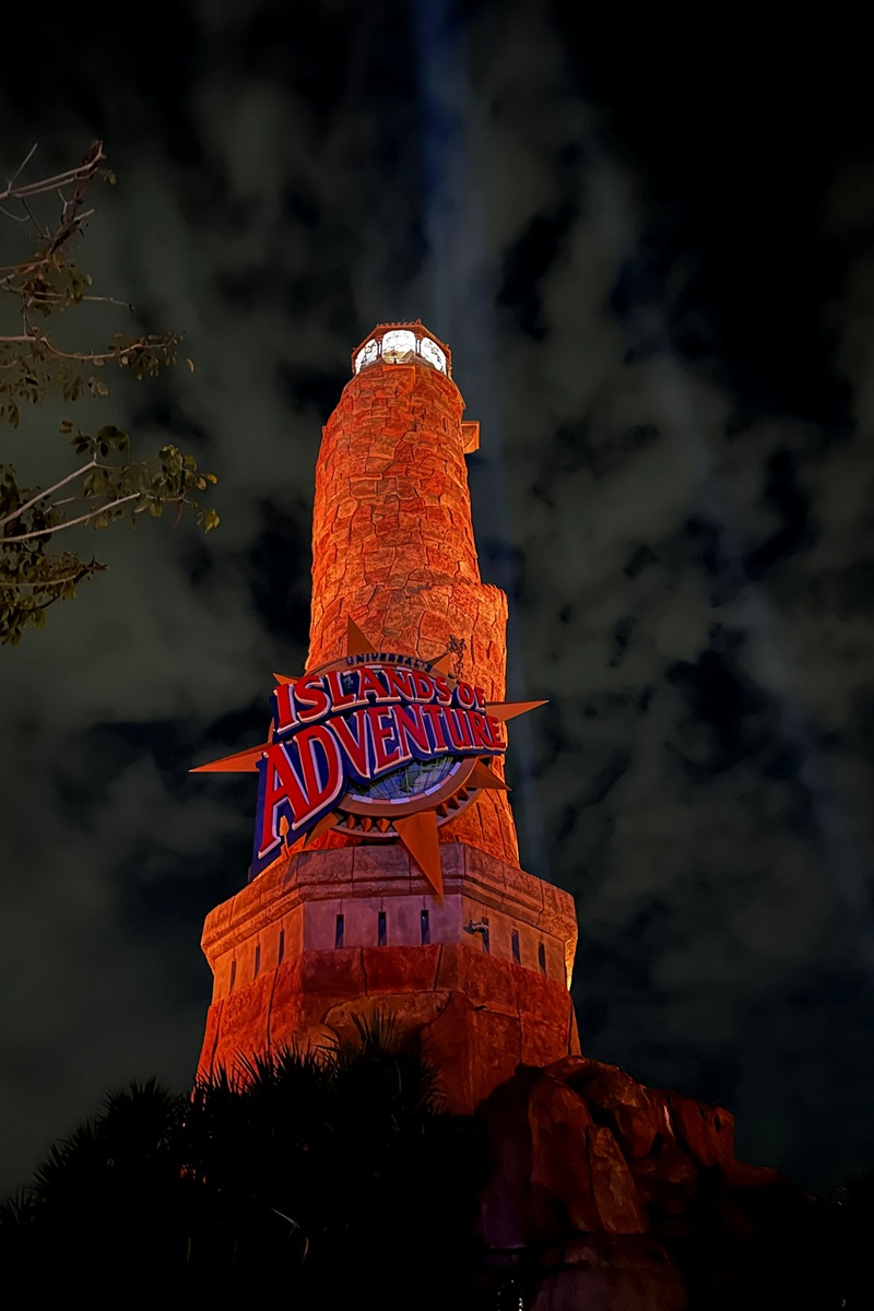 Islands of Adventure lighthouse lit up at night