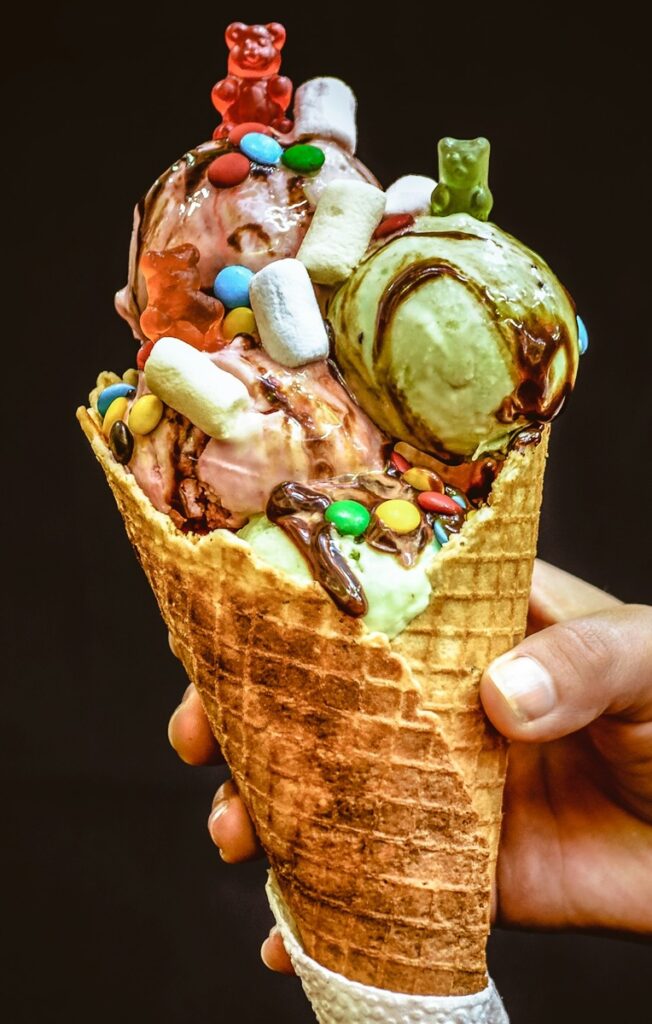 Ice cream in waffle cone with various toppings